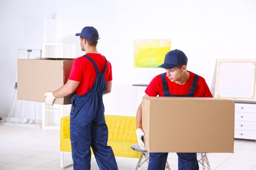 Removal team loading household items into a van